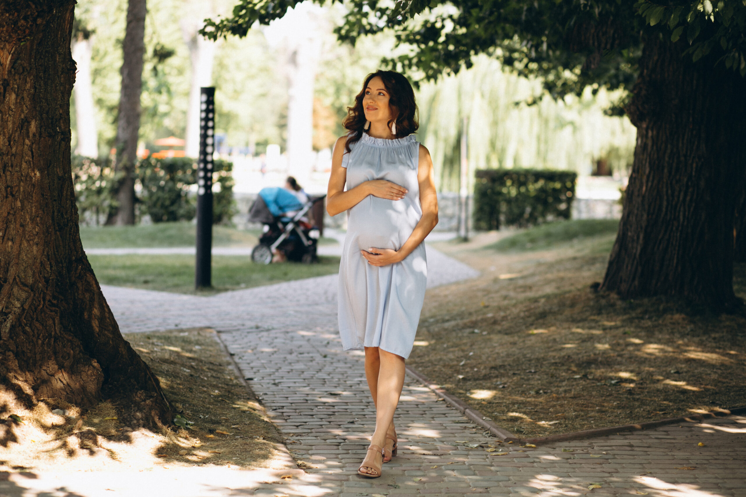 Pregnant woman posing in park